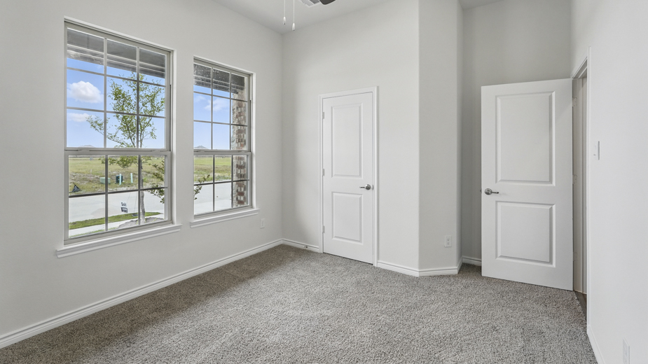 Bedroom with windows for natural lighting.