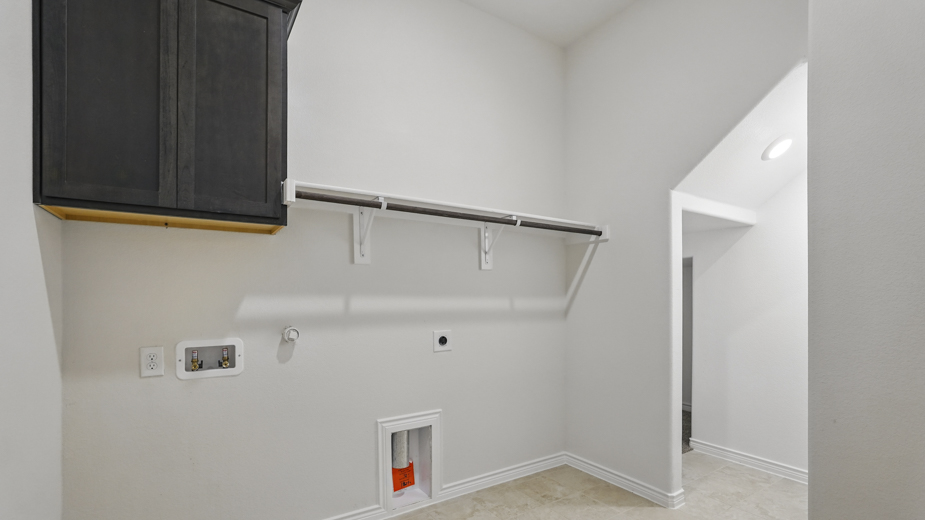 Laundry room with built in storage cabinet.