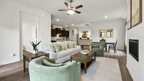 open concept living area with hardwood floors fire place