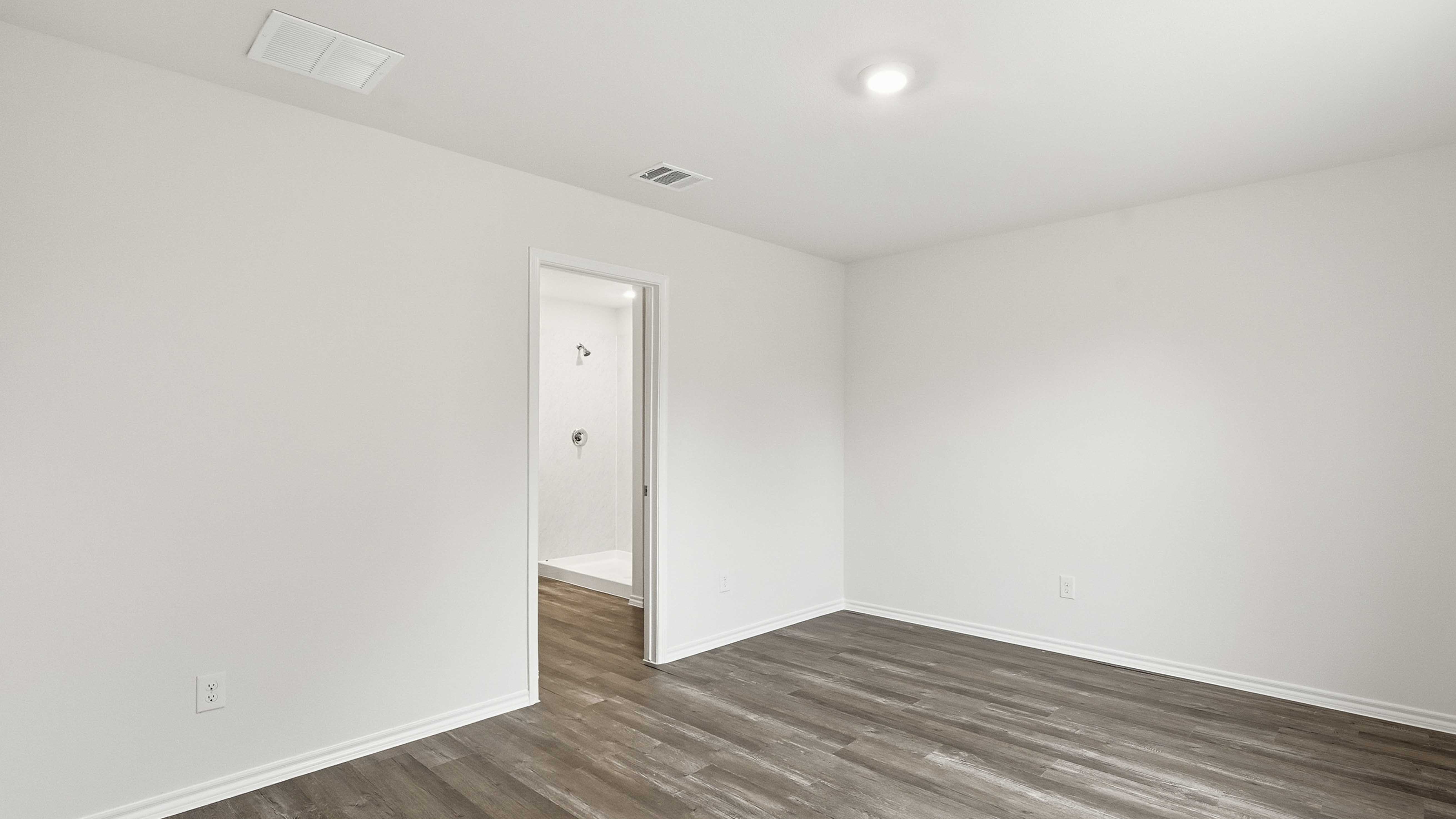primary bedroom with hardwood floors