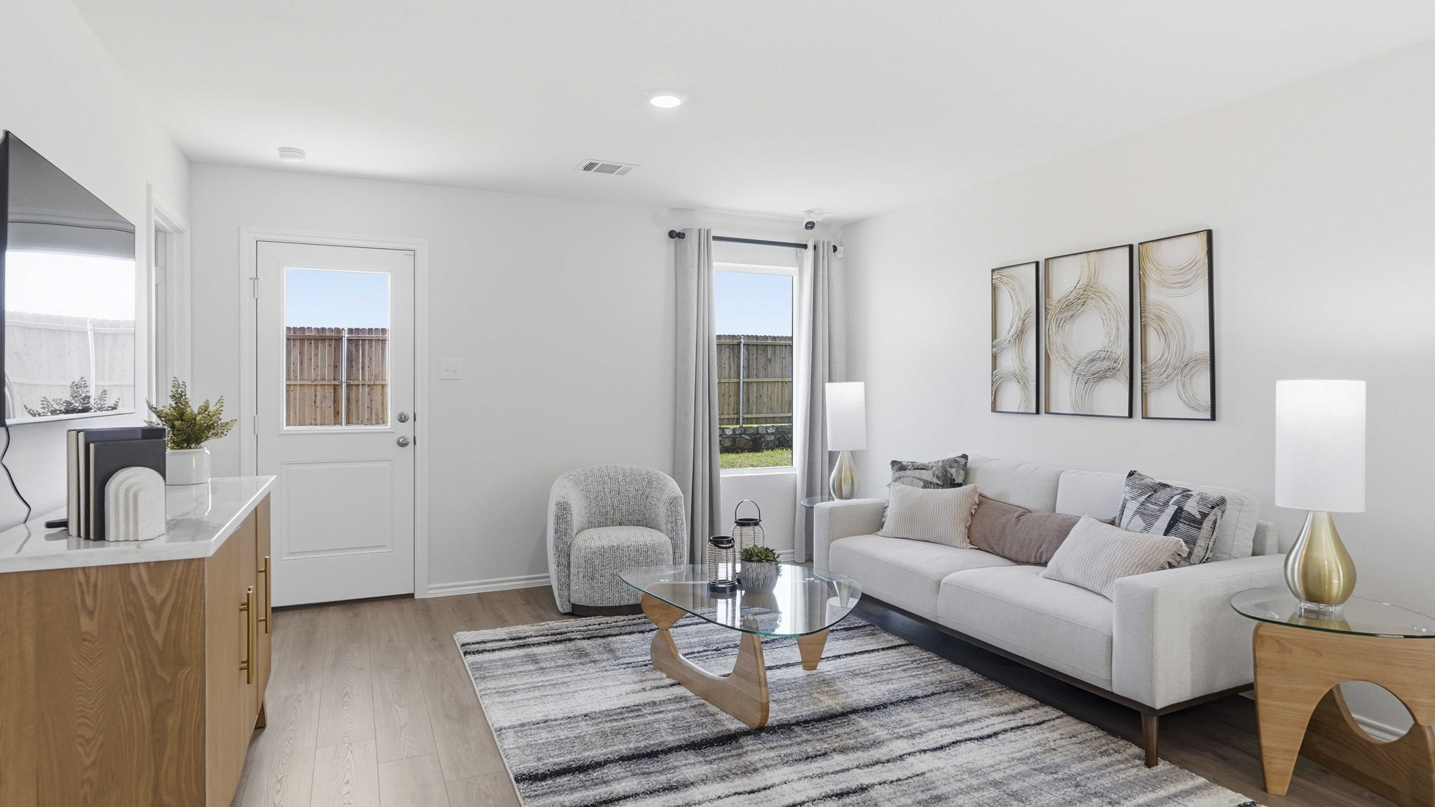 open concept living area with hardwood floors and large windows facing the backyard