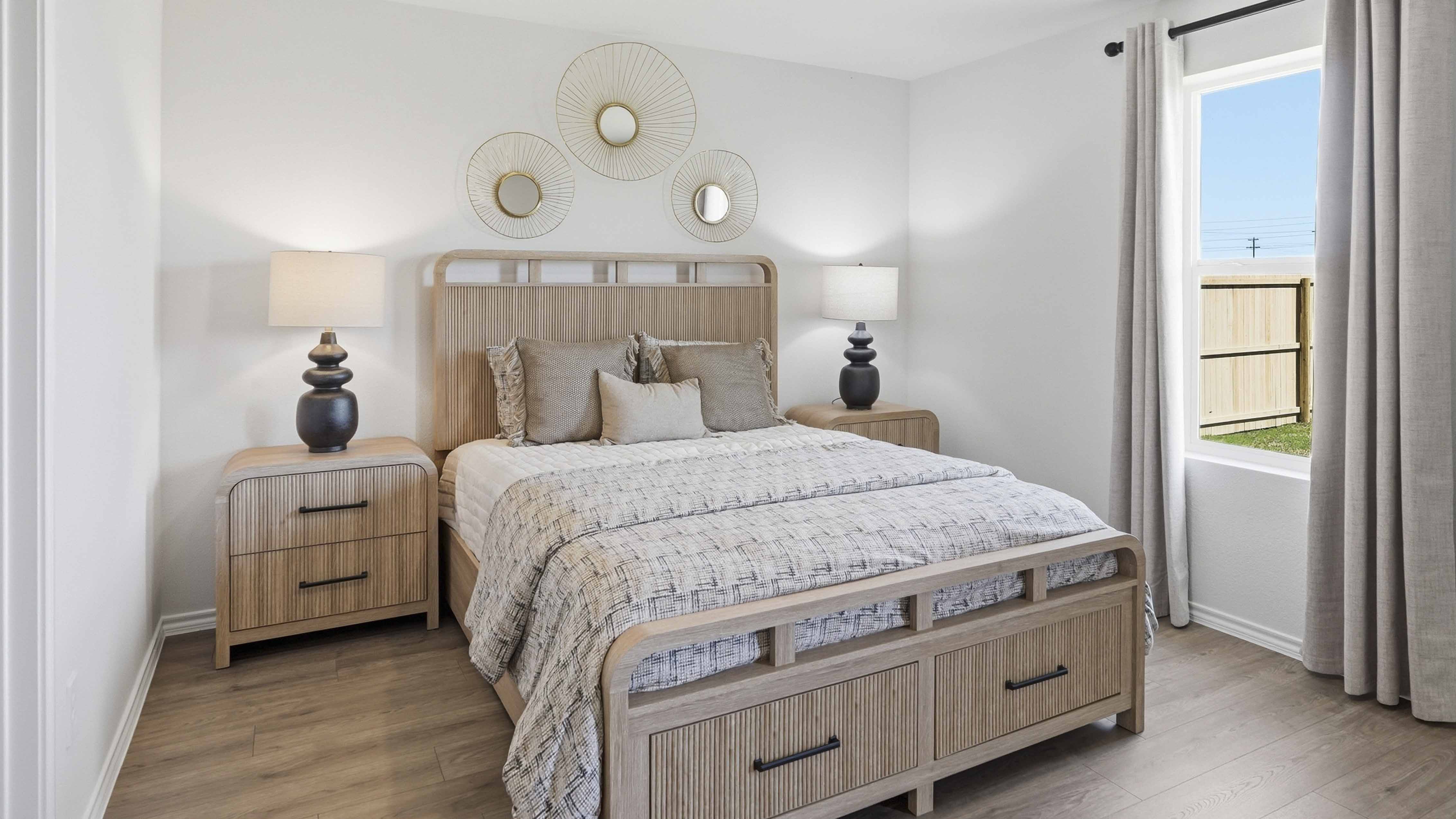 primary bedroom with carpet and large windows facing the backyard