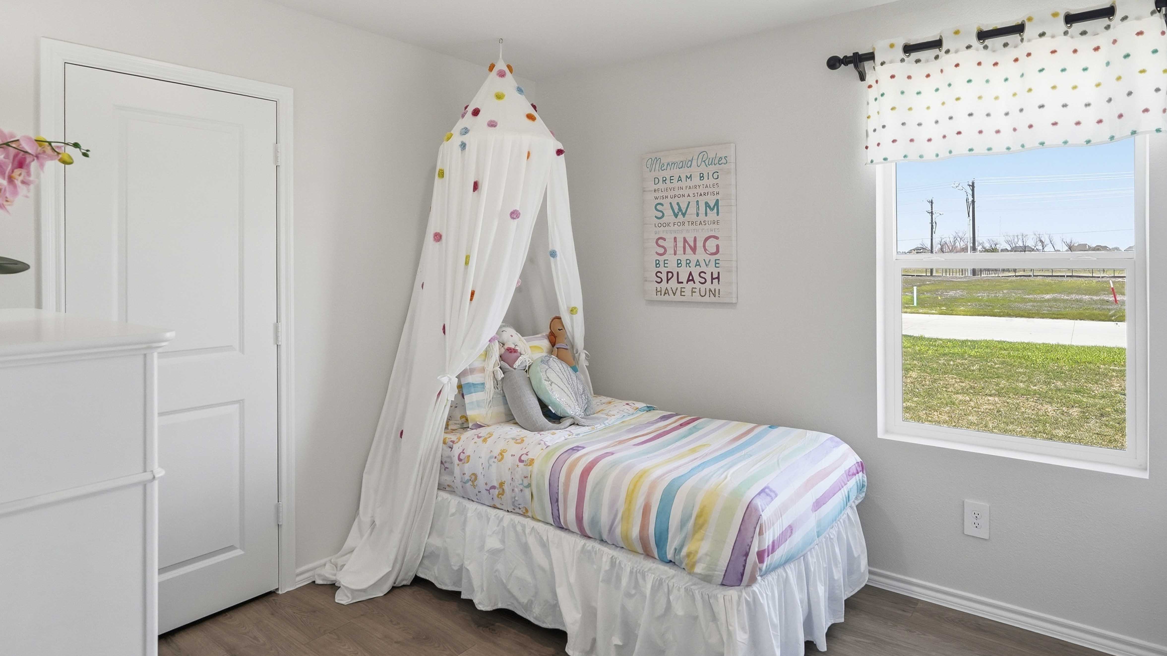 secondary bedroom with carpet white walls and large window