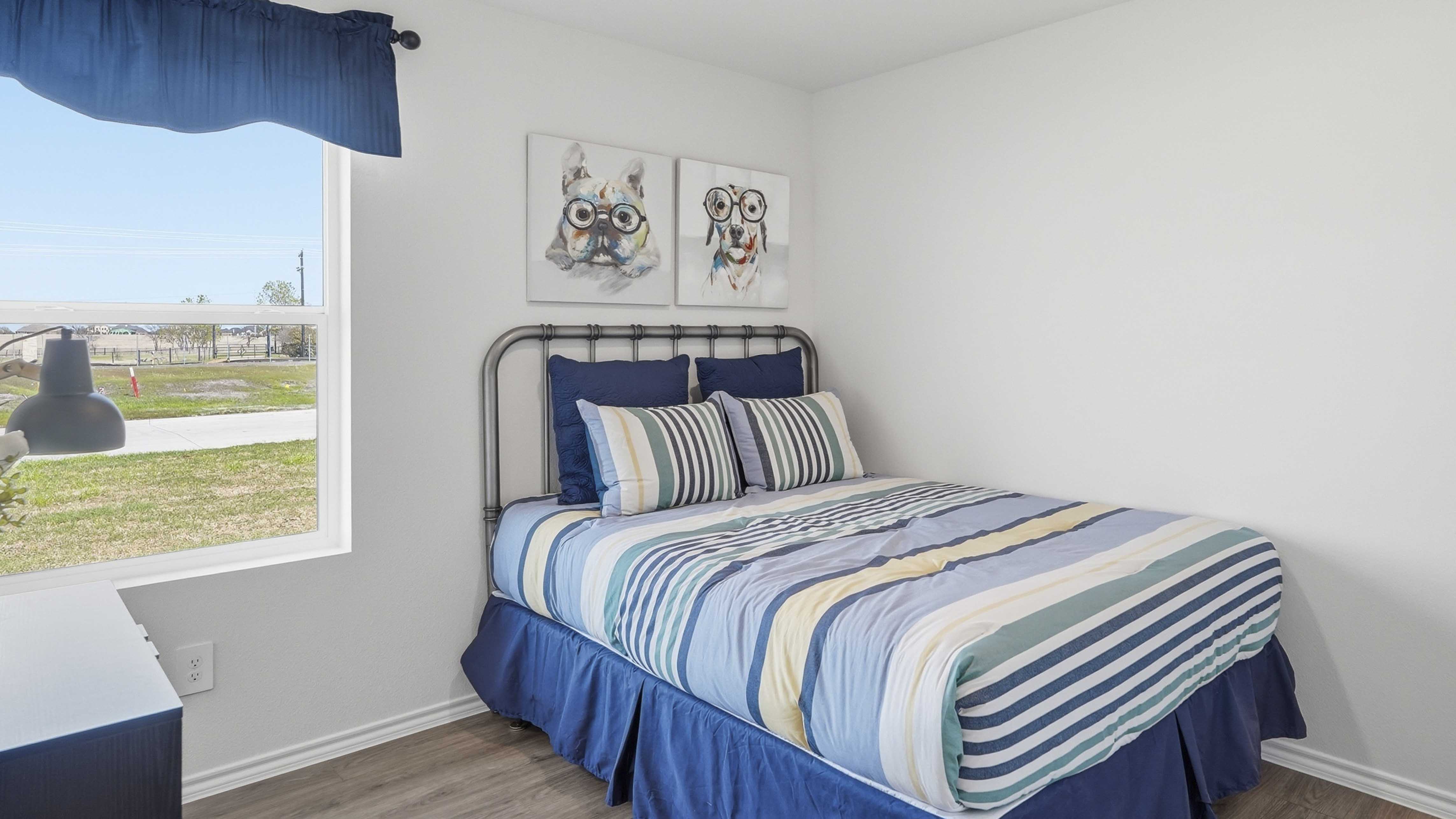 secondary bedroom with carpet white walls and large window