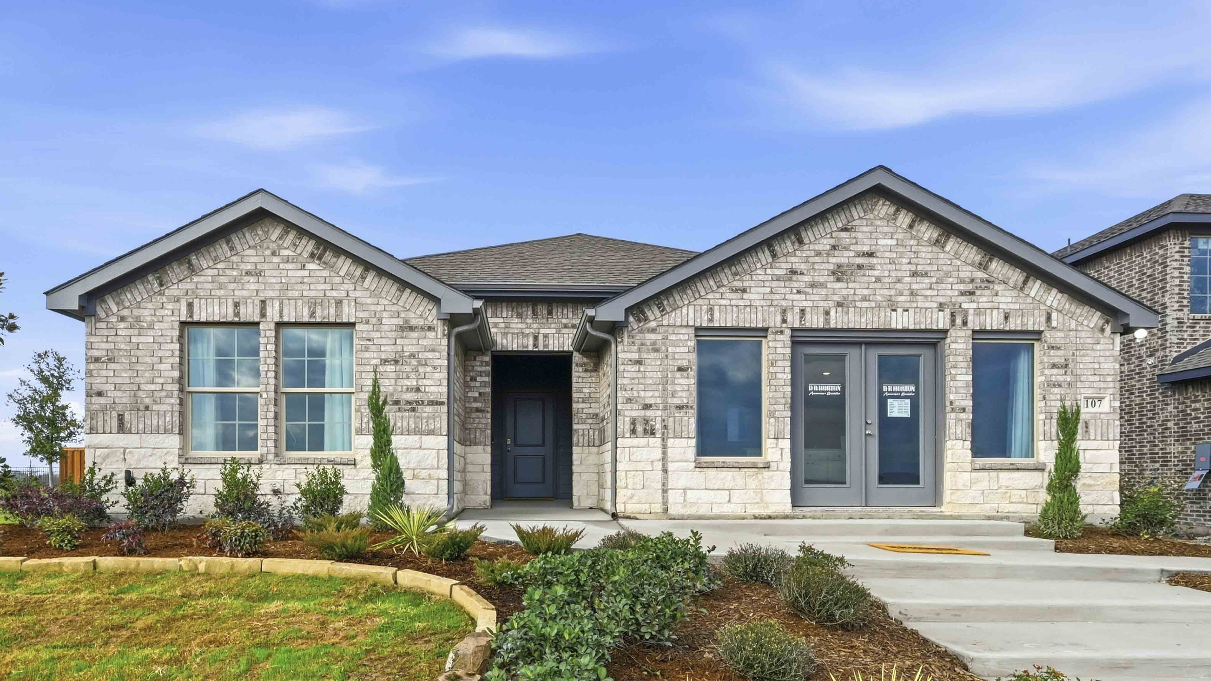 exterior of model home with brick and stone exterior