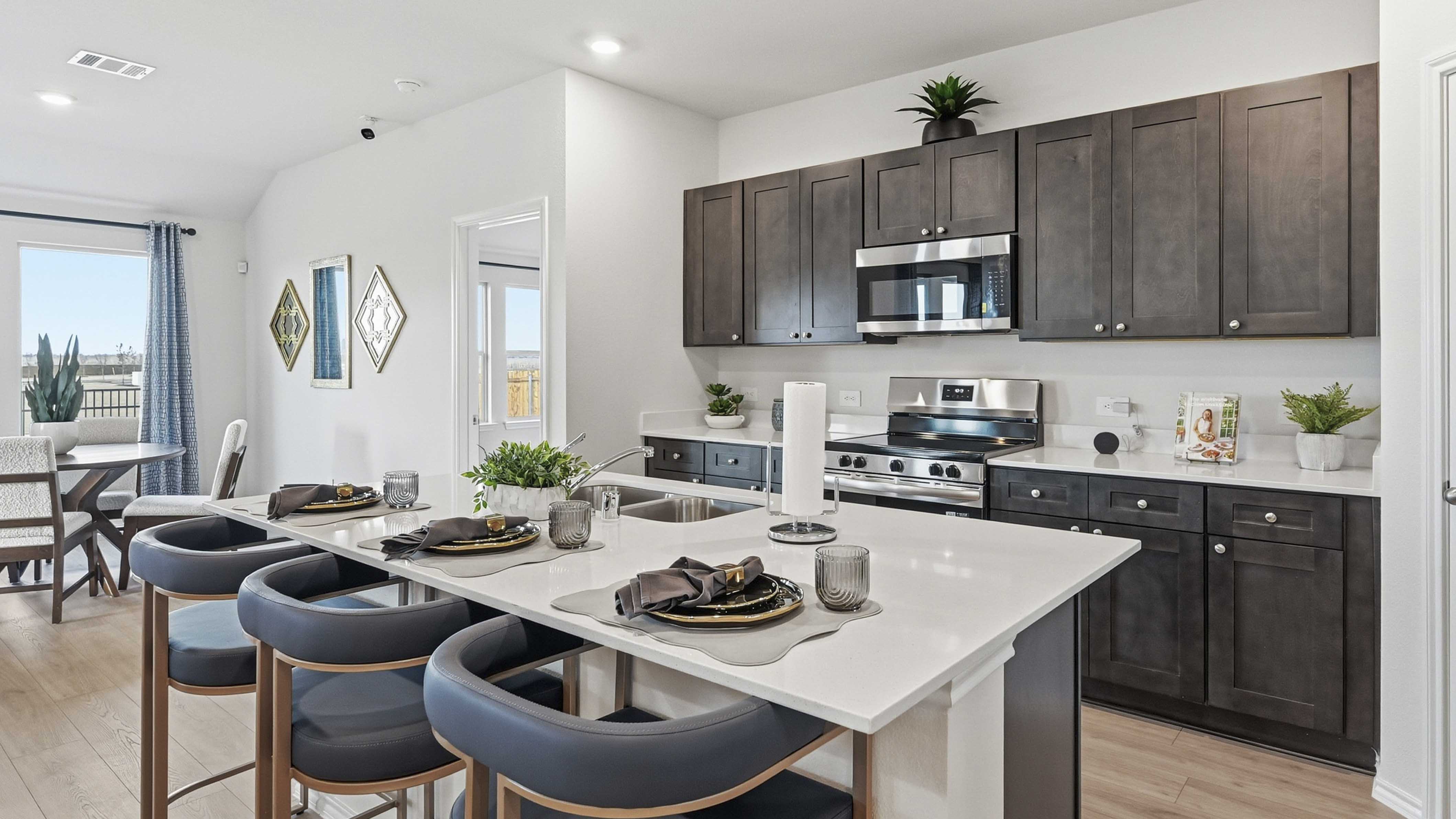 kitchen are with dark colored cabinets white countertops and kitchen island