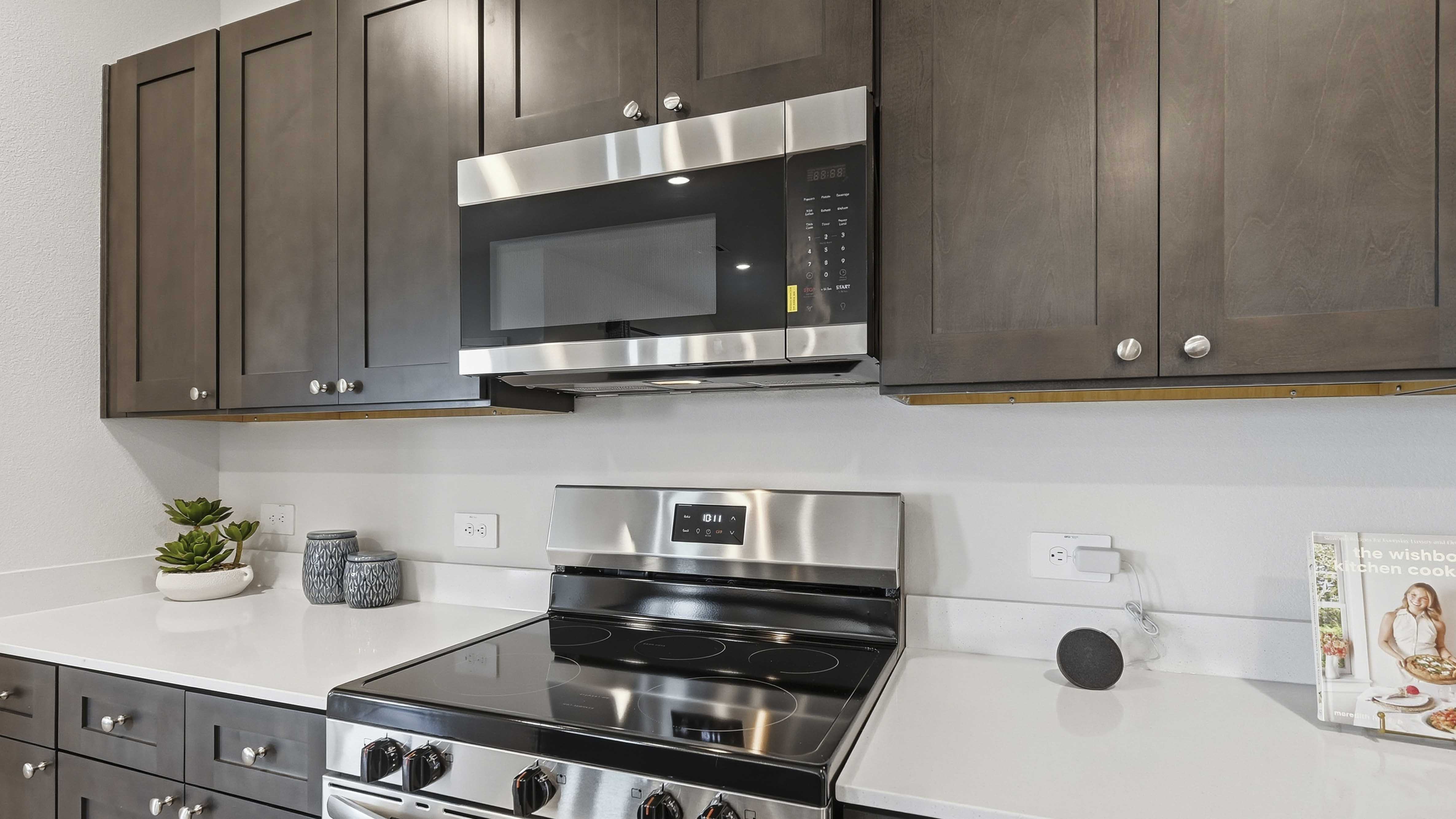 kitchen are with dark colored cabinets white countertops and kitchen island