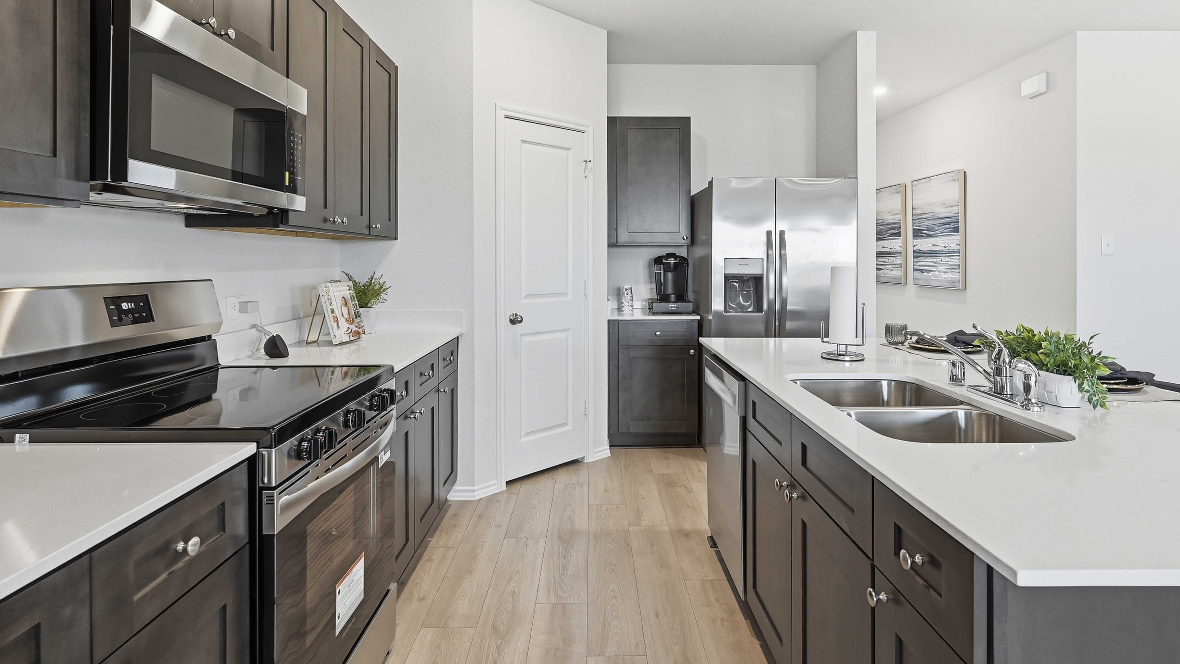 kitchen are with dark colored cabinets white countertops and kitchen island