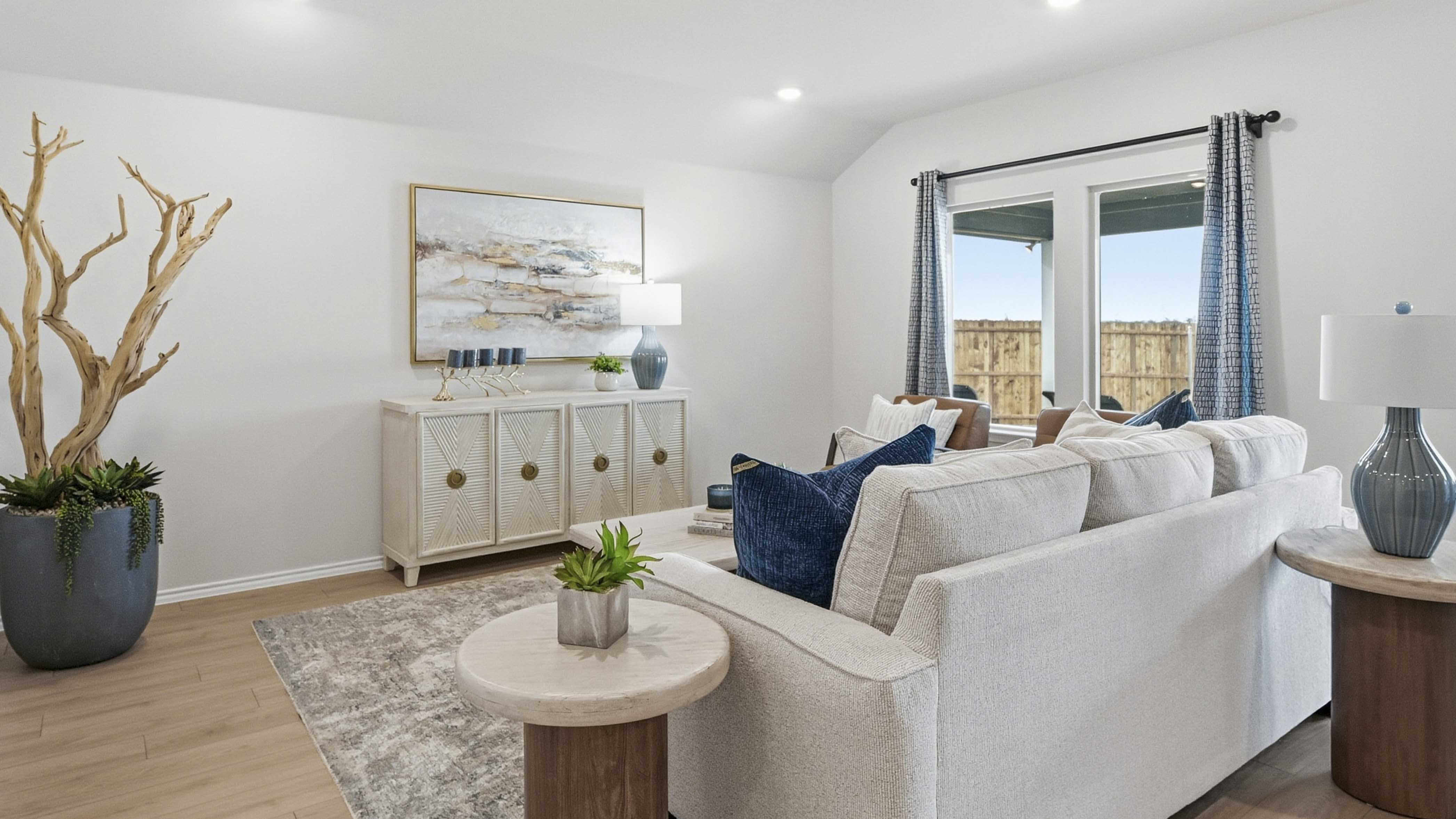 open concept living area with hardwood floors and large windows providing natural light