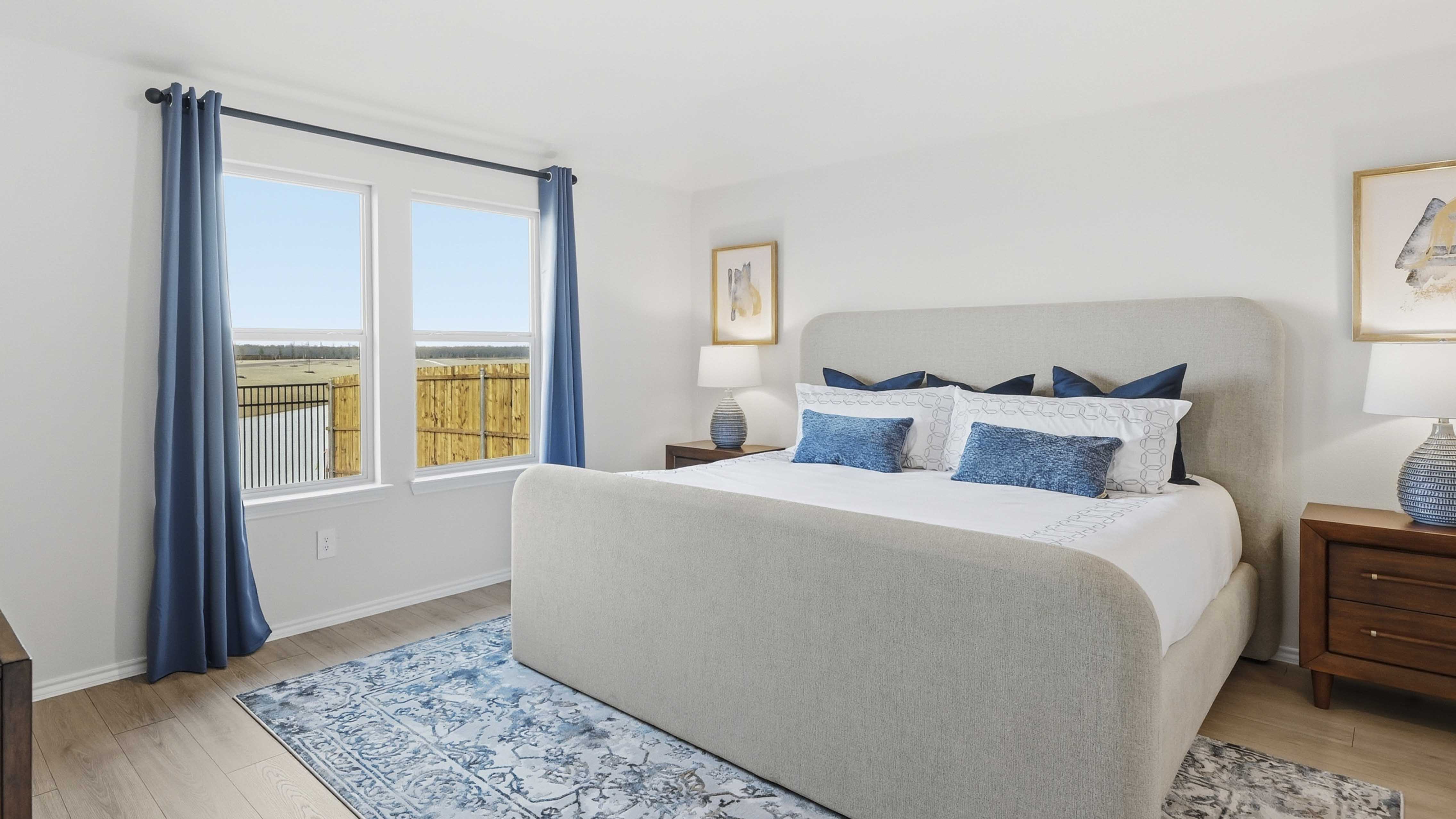 primary bedroom with large windows providing natural light