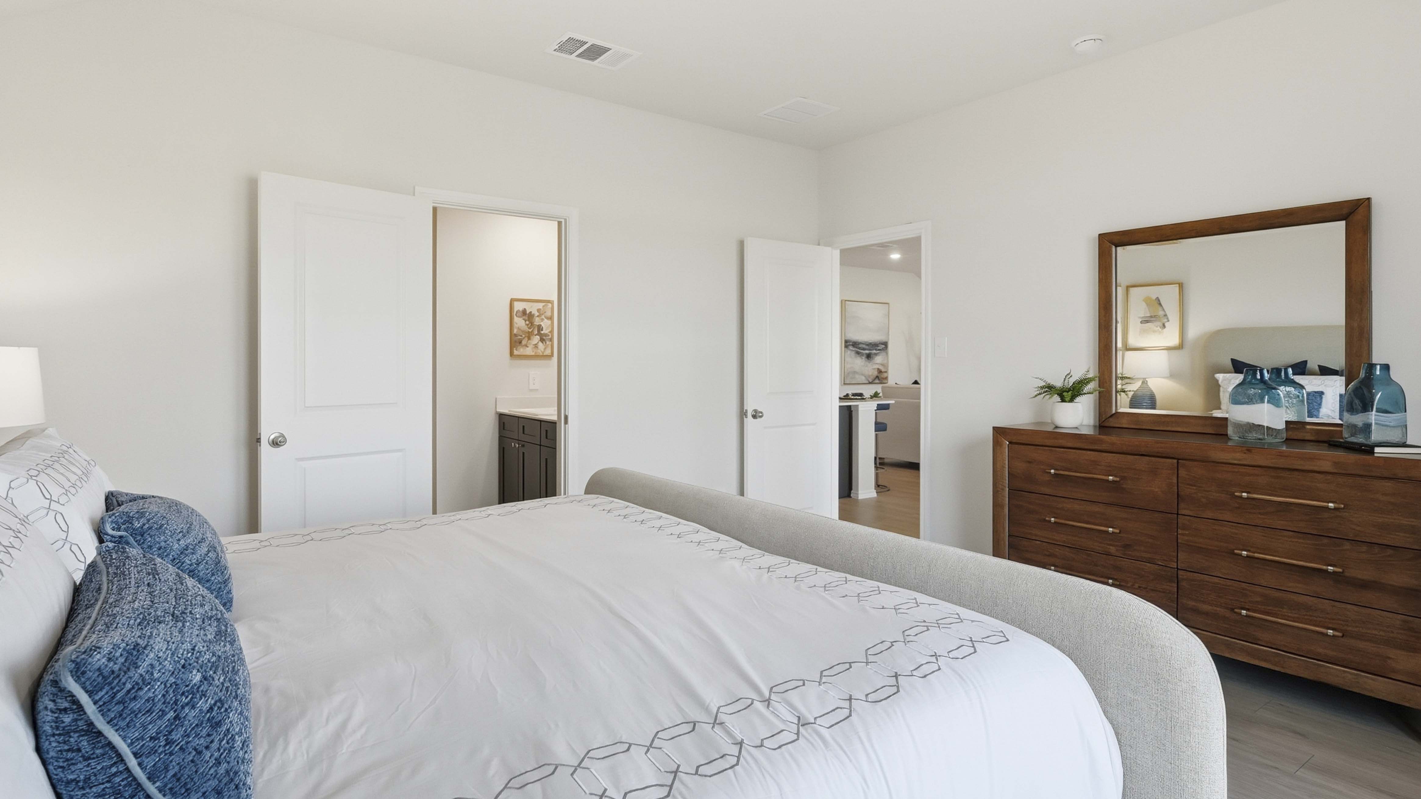 primary bedroom with large windows providing natural light