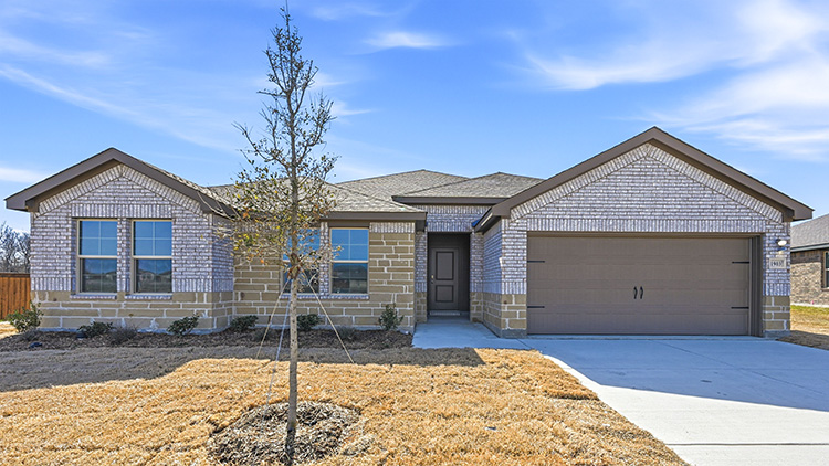 exterior of one story home with light colored brick and stone