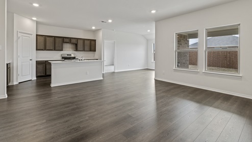 Living room with windows next to kitchen