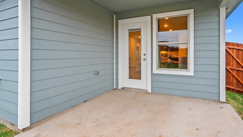 Back patio with blue siding and window