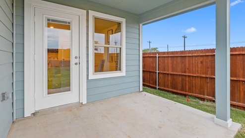 Back patio with blue siding and window