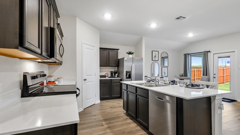Kitchen island with white countertops and brown cabinets