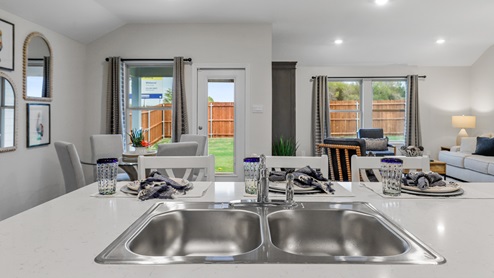 Kitchen island with views into breakfast nook and living room