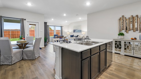 Kitchen island with views into breakfast nook and living room