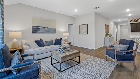 Living room with furniture and open concept view into kitchen