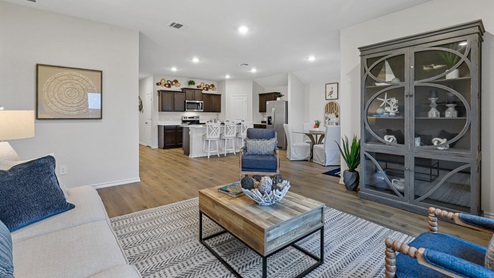 Living room with furniture and open concept view into kitchen