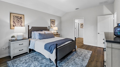 Primary bedroom with large window and furniture