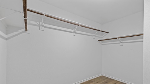 Walk in closet with hanging rods