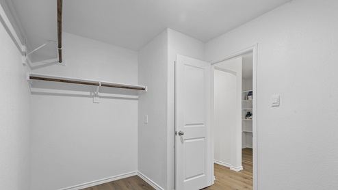 Large Walk in closet with hanging rods