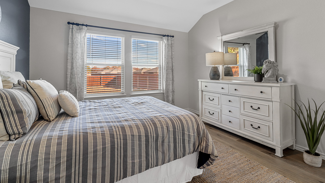 primary bedroom with carpeted floors and large window