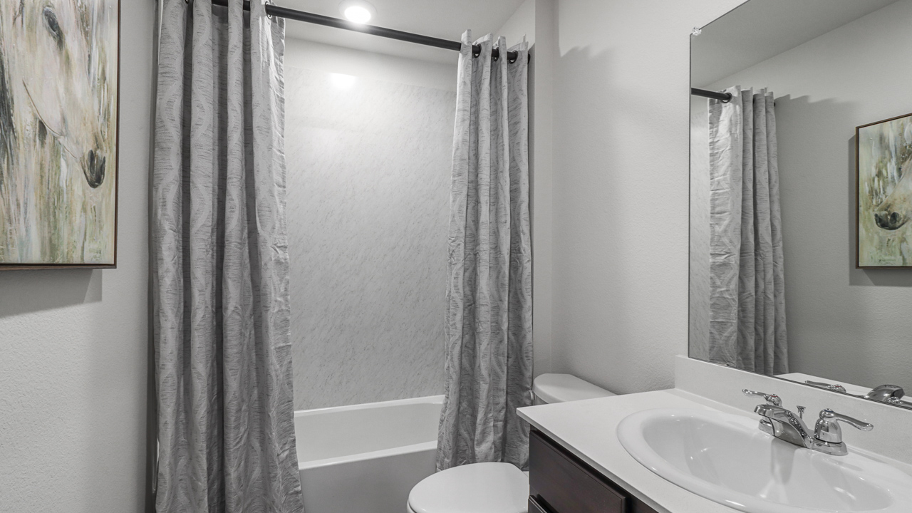 secondary bathroom with combined bathtub and shower