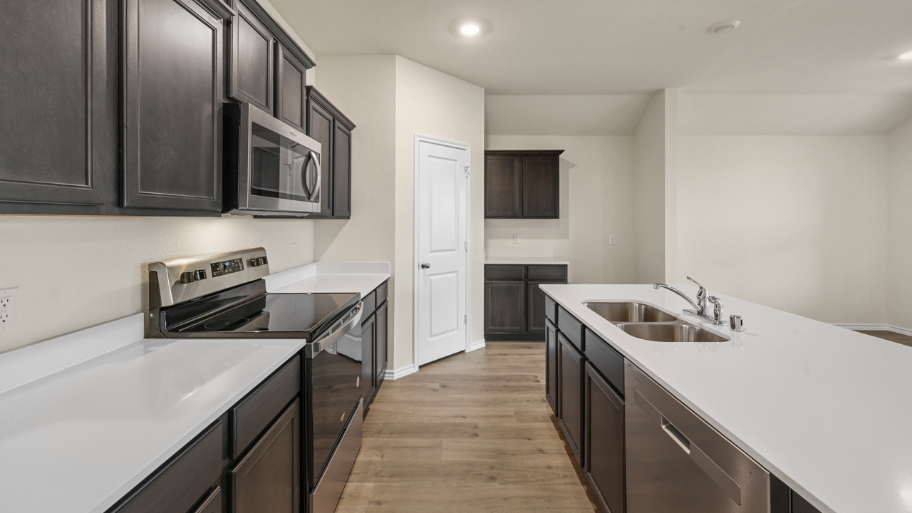 kitchen with brown cabinets and white counters