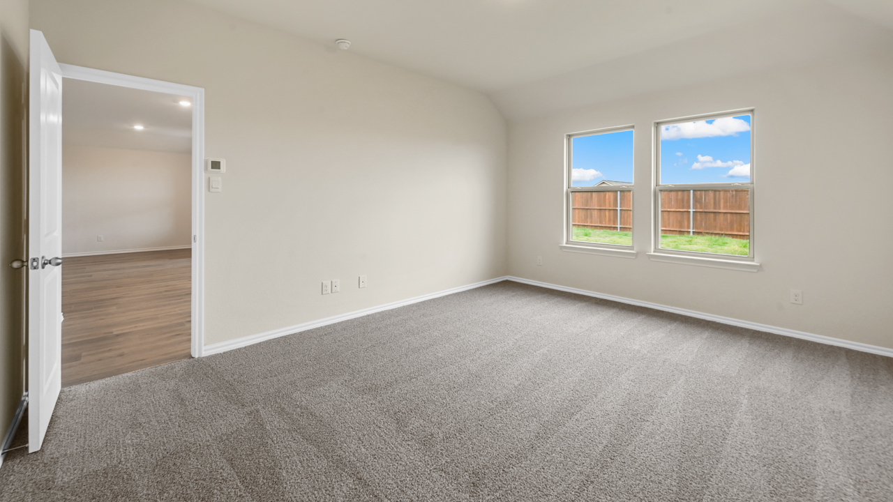 primary bedroom with carpet and window