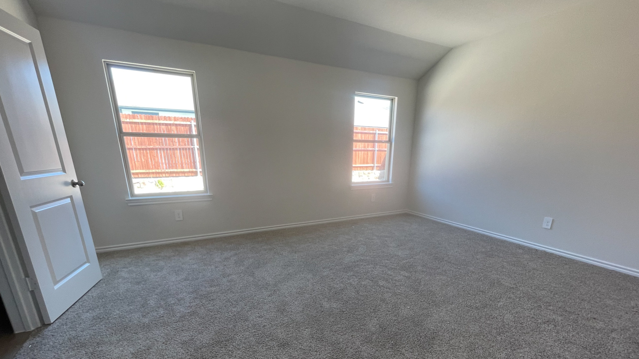 primary bedroom with large windows providing natural light
