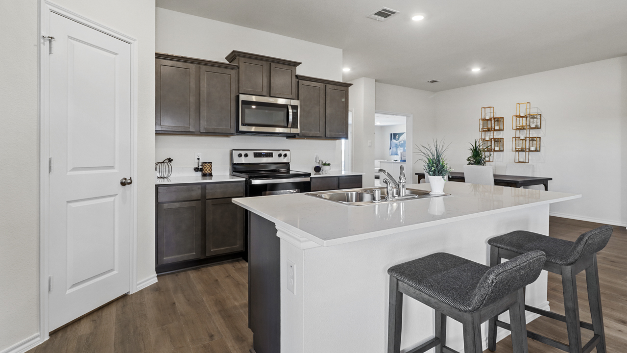kitchen featuring dark brown cabinets and white countertops