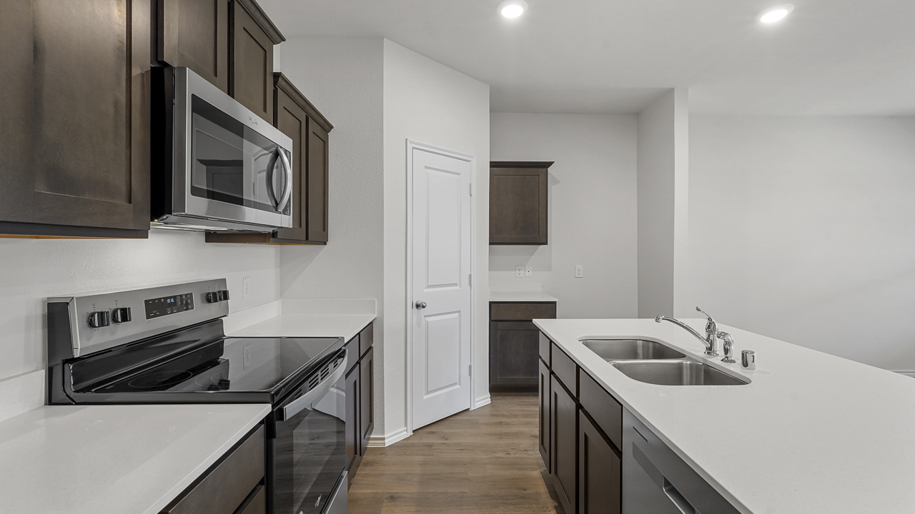 kitchen with brown cabinetry and white counters