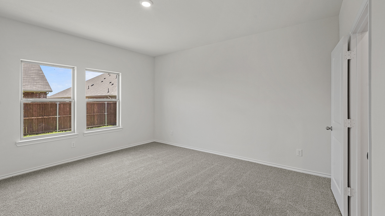primary bedroom with carpeted floors