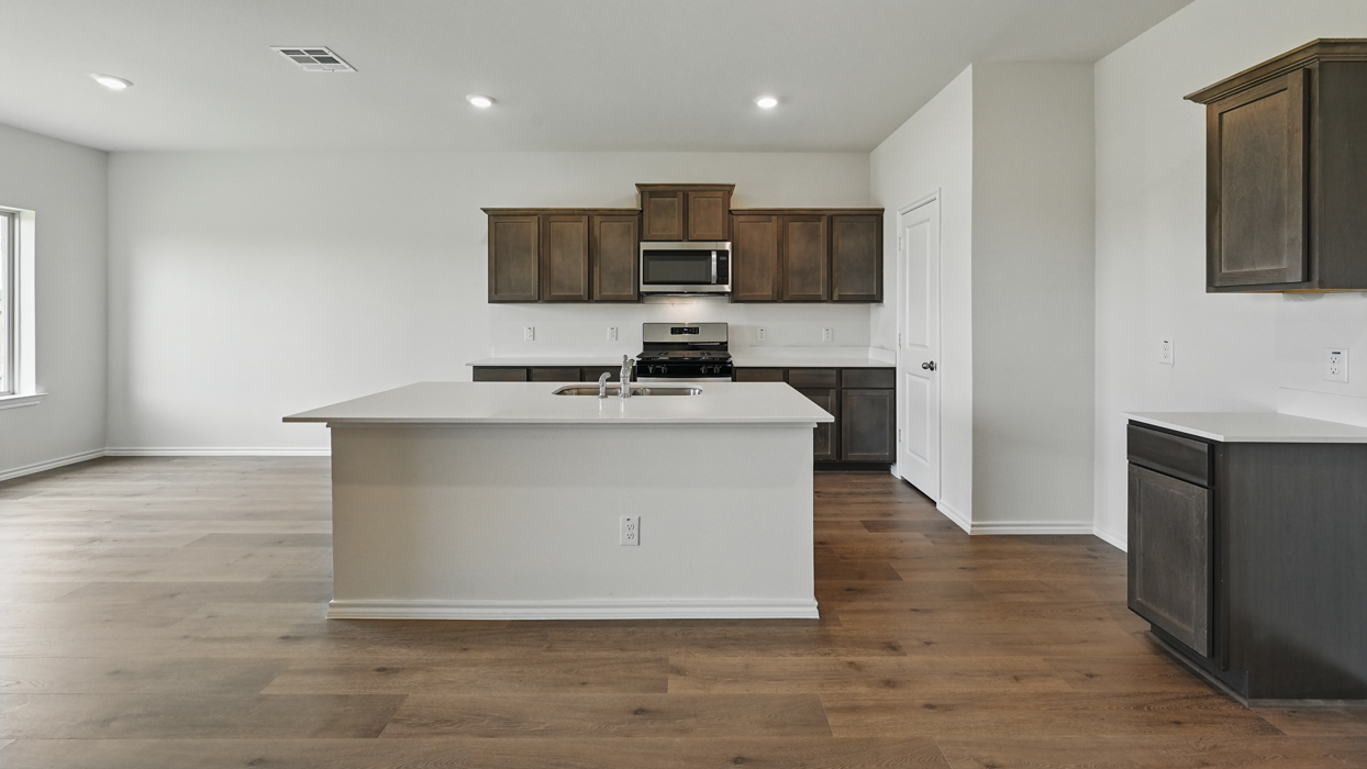 kitchen with island and brown cabinets