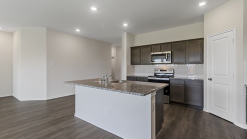 E40A kitchen area with granite counters and dark cabinets
