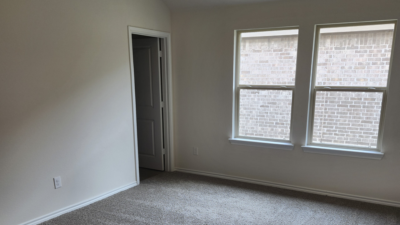 primary bedroom with large windows providing natural light