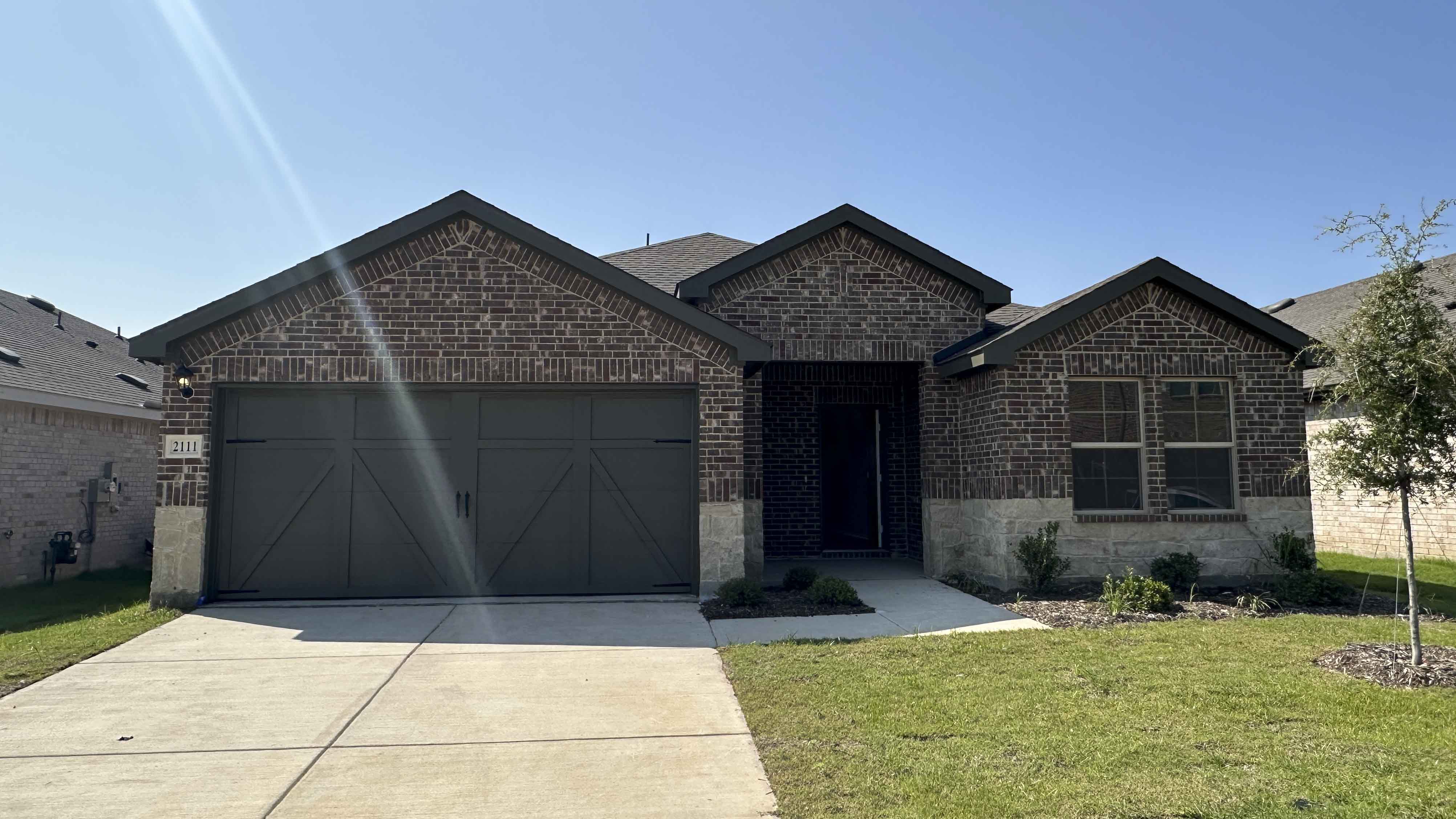 exterior of one story home with brick and stone