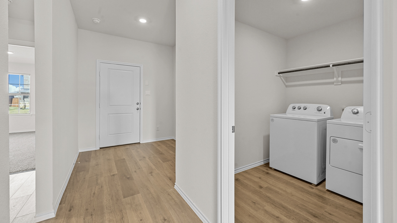 a hallway of a home with a door leading to a laundry room