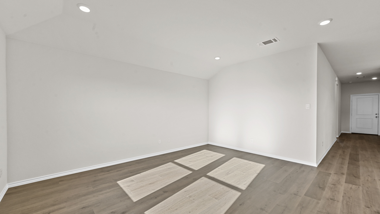 an empty living area with white walls and wood floors
