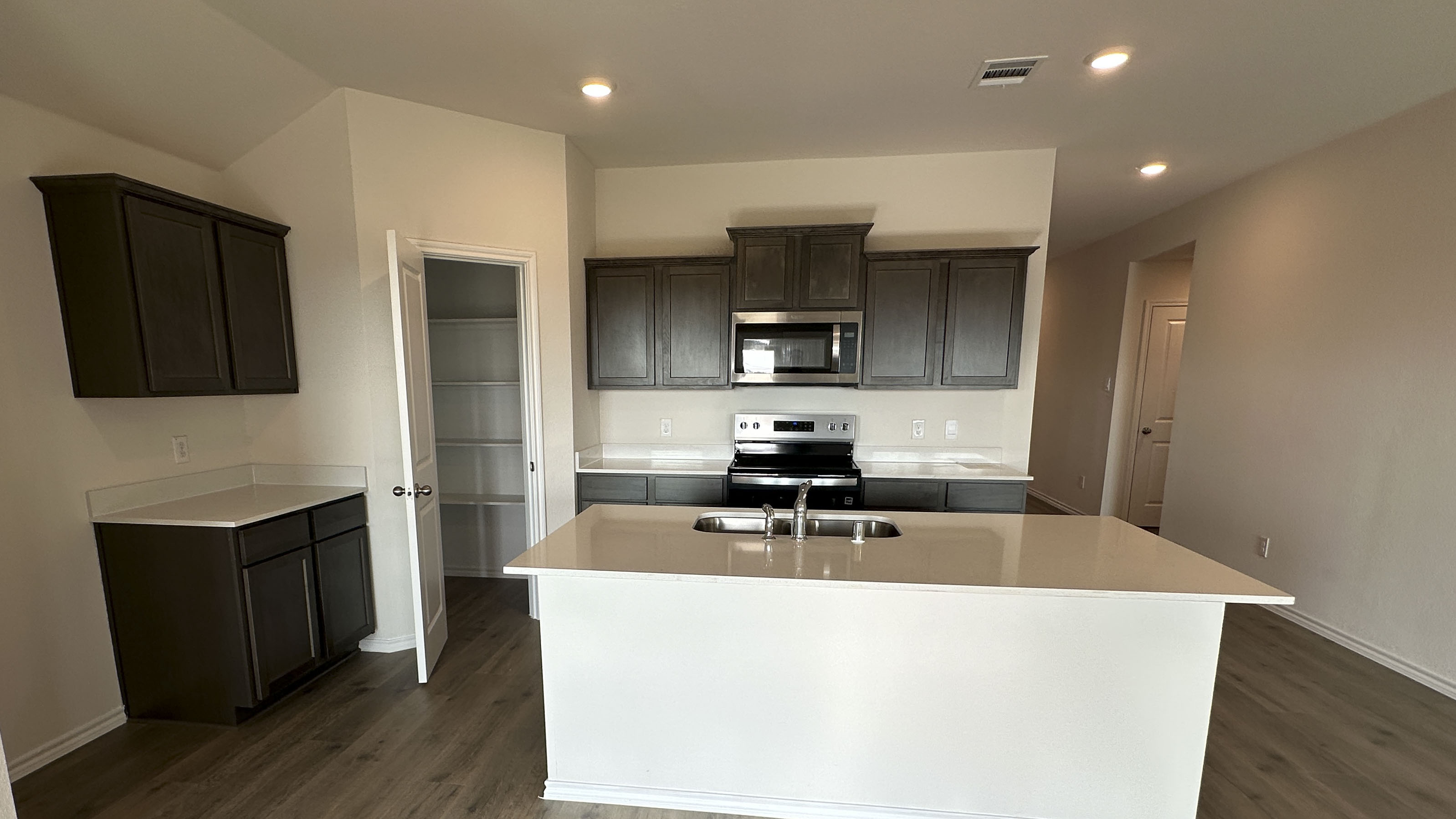 kitchen area with dark cabinets and light colored counters