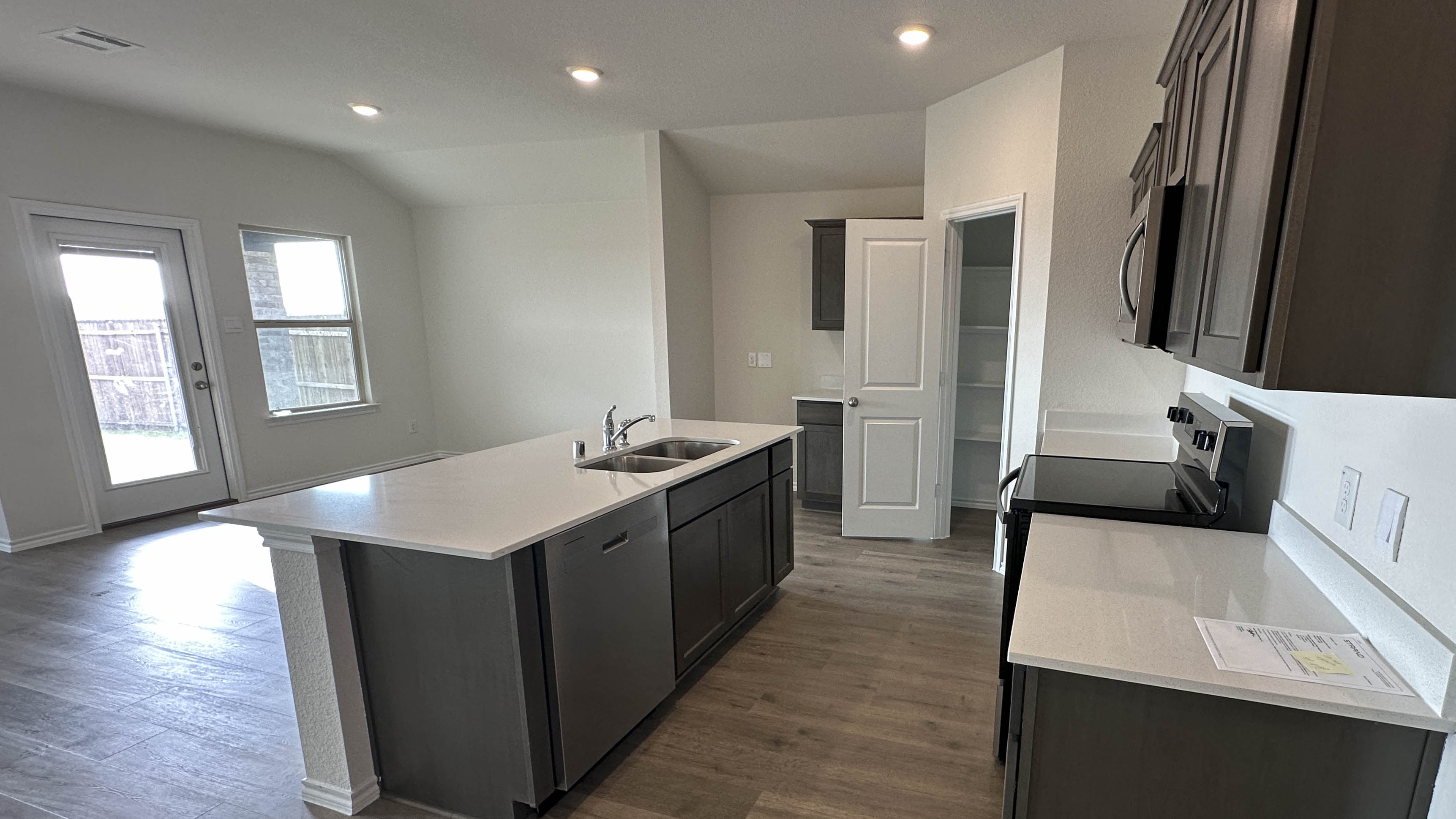 kitchen area with hardwood floors and light colored counters