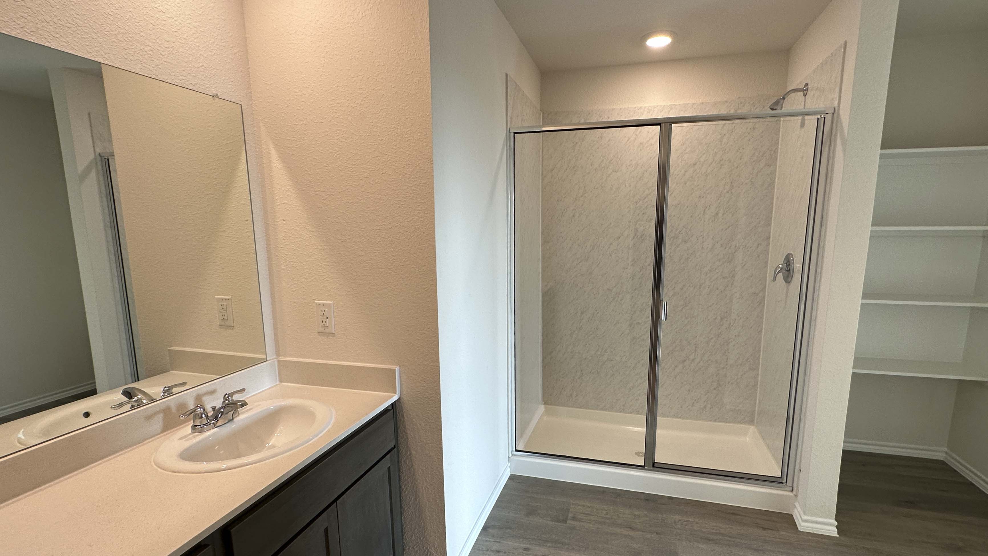 primary bathroom with hardwood floors