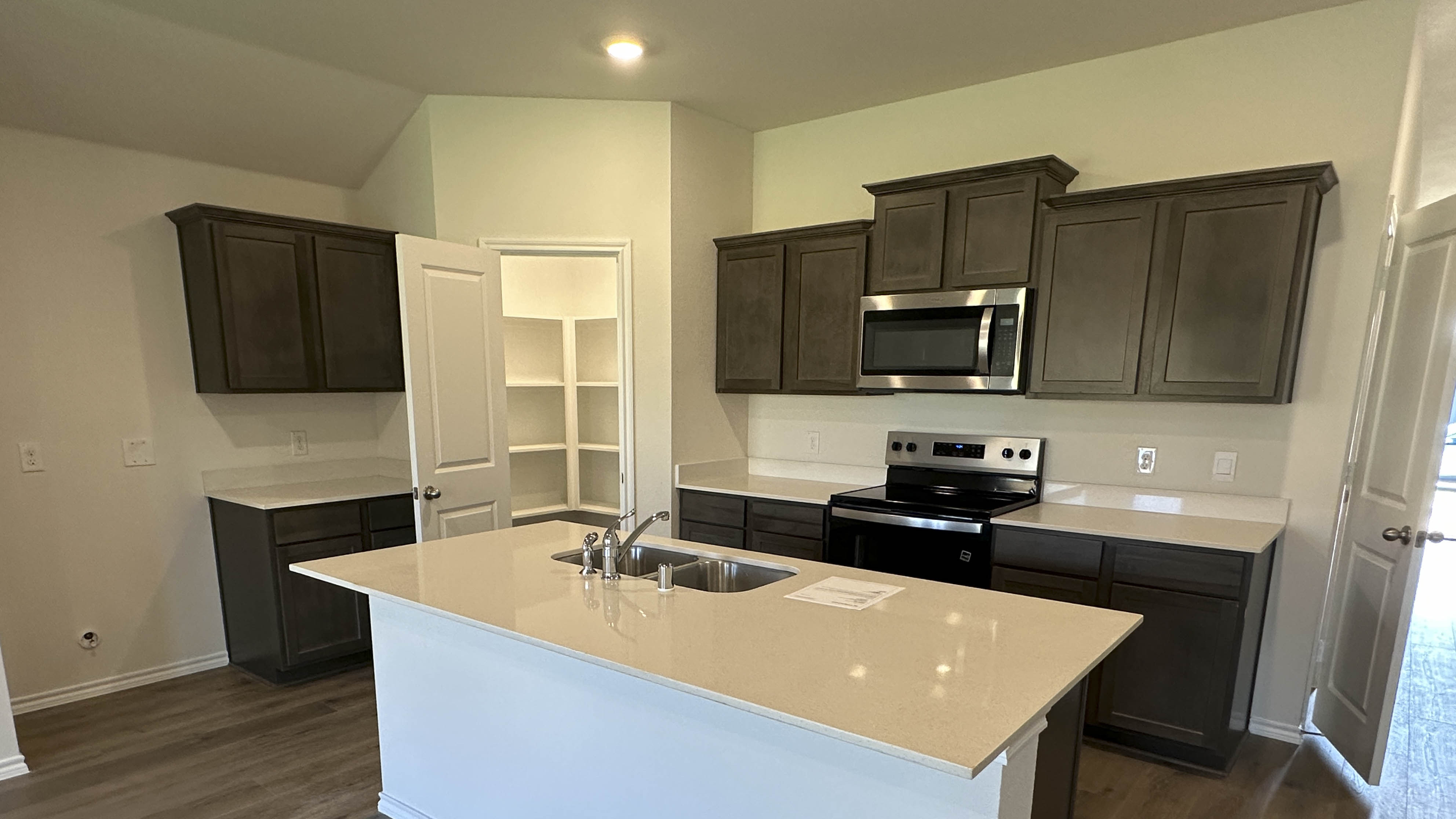 kitchen area with dark cabinets and light colored cabinets