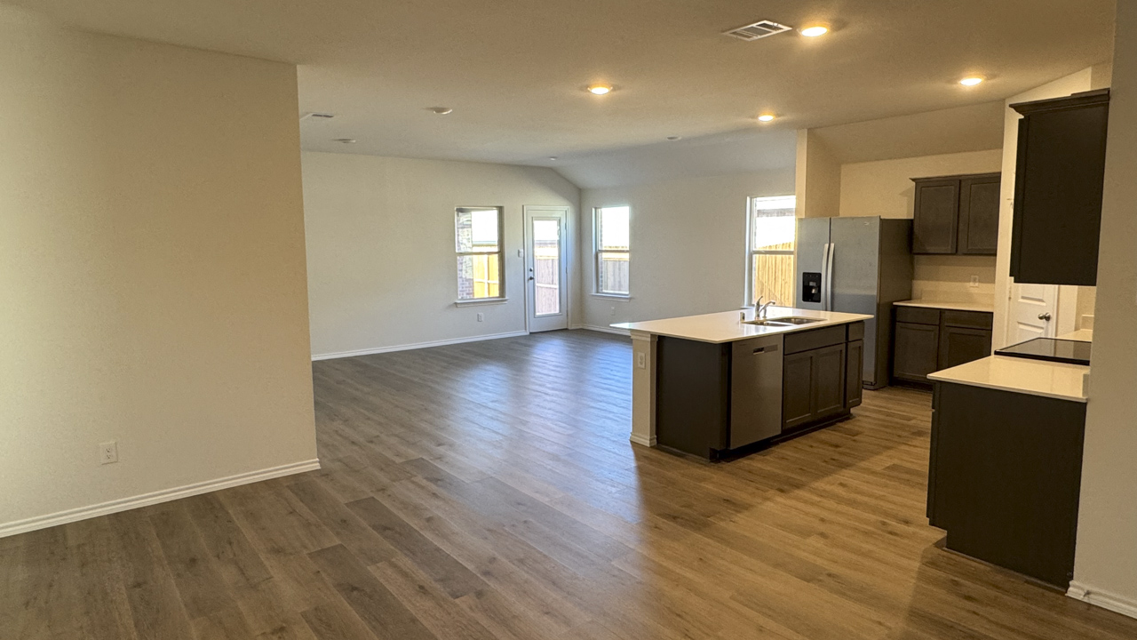 kitchen and living area with hardwood floors and large windows