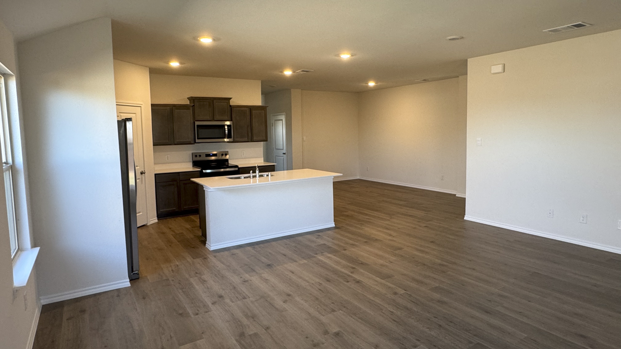 open concept living area with large windows providing natural light
