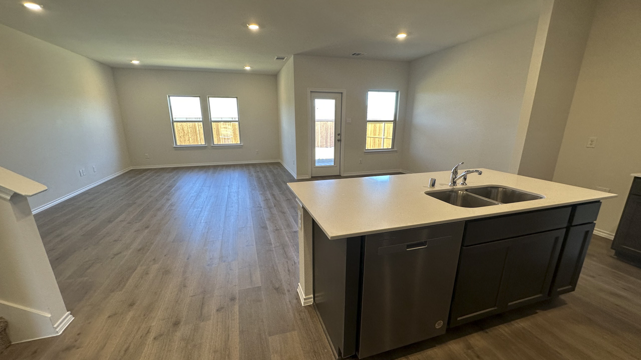 kitchen area with white counters and dark cabinets