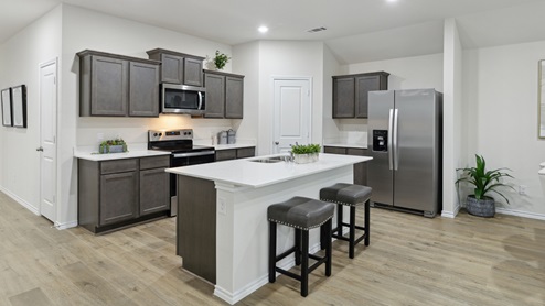 2106 Woodrose Court One-story model at Cartwright Ranch in Crandall, TX kitchen area with white counters and dark cabinets