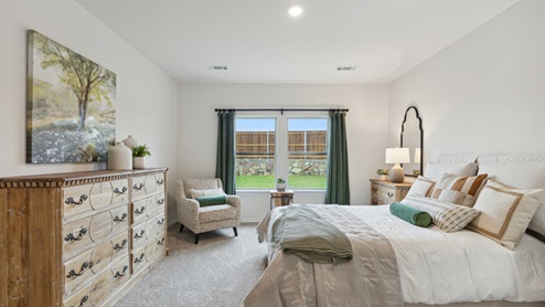 2110 Woodrose Court two-story model at Cartwright Ranch in Crandall, TX primary bedroom with carpet and natural lighting